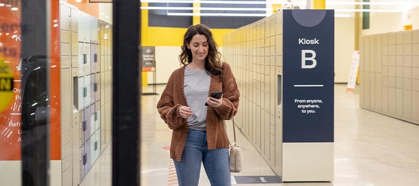 Woman looking at her Parcel Pending mobile app in the Premier Parcel location.