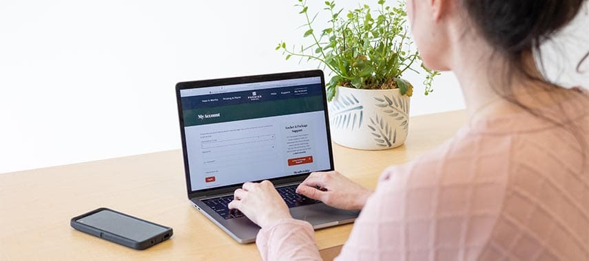 woman looking on at her computer wit webiste up